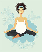 练习瑜伽的孕妇。