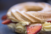 奶油泡芙环，开心果奶油和新鲜草莓，传统的法国泡芙-库存形象