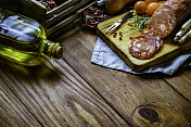 放着意大利香肠和西班牙香肠的小菜一碟放在一张有复印空间的质朴木桌上