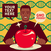 英俊的非裔美国人吃着一个大苹果(转基因食品)，基因工程，转基因和基因操纵的概念