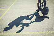 一个男人在停车场骑自行车的影子。