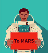 微笑英俊的宇航员(宇航员)不戴头盔,举着一个写有“到火星”的牌子,探索火星,火星移民,太空旅行和探索,外层空间竞争 微笑英俊的宇航员(宇航员)不戴头盔,举着一个写有“到火星”的牌子,探索火星,火星移民,太空旅行和探索,外层空间竞争