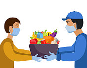 网上购物和送货。从便利店、杂货店、超市等网上购买的商品送货上门。水果和蔬菜的包装。人们戴着口罩和手套。媒介人采取预防covid-19和疾病