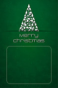 一棵白色的三角形圣诞树滑进了一条狭缝里，绿色的点缀着雪花的背景上写着“圣诞快乐”的短信，底部还有一个空白的收件人和地址文本框