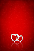 银白色三维或三维垂直与两个纠缠的心在黑暗明亮的充满活力的红色褐红色节日发光闪闪的模糊矢量背景为情人节或周年爱情浪漫的贺卡，海报和横幅