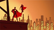 向量超级英雄夫妇剪影在一个城市