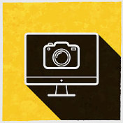 带摄像头的台式电脑。图标与长阴影的纹理黄色背景