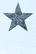 一个深灰色斑点星形标志或符号在浅天蓝色污迹斑斑的旧纸或纸板纹理抽象矢量背景与复制空间