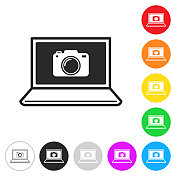 笔记本电脑和相机。彩色按钮上的图标