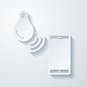 带有智能手机的智能灯泡。空白背景上剪纸效果的图标