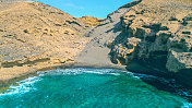 Aerial view of the hidden cove beach "La Rajita" at the natural reserve of "Monta?a Pelada" in Tenerife (Canary Islands). Drone shot