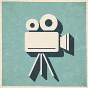 带三脚架的电影摄影机。图标复古复古风格-旧纹理纸