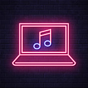笔记本电脑上的音乐。在砖墙背景上发光的霓虹灯图标