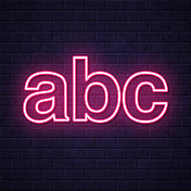 Abc字母。在砖墙背景上发光的霓虹灯图标