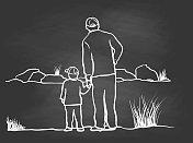 父亲和儿子在池塘黑板前