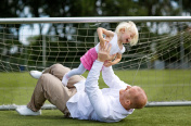 父亲和女儿在足球场上玩耍