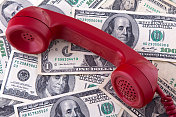 老式的红色电话听筒上印着美元