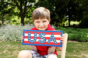 小男孩举着美国国旗