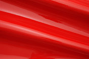 红色发光乙烯波纹理背景的特写